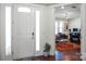 Bright entryway features a white door with glass sidelights and hardwood floors leading into the house at 15018 Marymont Ave, Huntersville, NC 28078