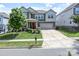 Beautiful home with a well-maintained lawn, spacious driveway, and classic architectural details at 15018 Marymont Ave, Huntersville, NC 28078