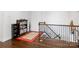Hallway staircase with wood floors, wrought iron railing, and a view to the level below at 15018 Marymont Ave, Huntersville, NC 28078