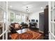 Cozy living room featuring hardwood floors, area rug, lots of natural light, and a comfortable leather chair at 15018 Marymont Ave, Huntersville, NC 28078