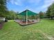 Community playground featuring slides, climbing structures, swings, and a covered shade area at 15018 Marymont Ave, Huntersville, NC 28078