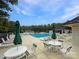 Large community pool area with lounge chairs and umbrellas in a tranquil setting perfect for relaxation and enjoyment at 15018 Marymont Ave, Huntersville, NC 28078