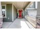 Inviting front porch with stylish lighting and a classic red front door at 15018 Marymont Ave, Huntersville, NC 28078