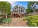 Backyard featuring a charming screened-in porch with stairs, stone landscaping, and a well-maintained lawn at 1600 Onslow Dr, Charlotte, NC 28205