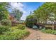 Tranquil backyard featuring mature trees, wooden fencing, and a cozy seating arrangement at 1600 Onslow Dr, Charlotte, NC 28205