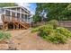 Backyard with a screened-in porch, stairs, and gravel ground, plus an appealing stone pathway through lovely landscaping at 1600 Onslow Dr, Charlotte, NC 28205