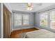 Bedroom with hardwood floors, windows with blinds, and a comfortable bed at 1600 Onslow Dr, Charlotte, NC 28205