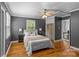 Comfortable bedroom with hardwood floors, ceiling fan, and neutral decor at 1600 Onslow Dr, Charlotte, NC 28205