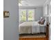 Bedroom with natural light from windows, hardwood floors, and a comfortable bed at 1600 Onslow Dr, Charlotte, NC 28205