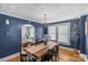 Charming dining room with hardwood floors, blue walls, and a decorative chandelier at 1600 Onslow Dr, Charlotte, NC 28205