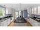 Bright, updated kitchen with stainless appliances, white cabinets, and a large center island at 1600 Onslow Dr, Charlotte, NC 28205