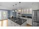 Updated kitchen with stainless steel appliances, a center island cooktop, and a doorway to the backyard at 1600 Onslow Dr, Charlotte, NC 28205
