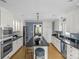 Spacious kitchen with stainless steel appliances, large island with seating, and white cabinetry at 1600 Onslow Dr, Charlotte, NC 28205