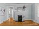 Spacious living room featuring a fireplace, hardwood floors, and views into other rooms at 1600 Onslow Dr, Charlotte, NC 28205