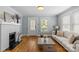 Bright living room with hardwood floors, brick fireplace, and neutral furniture, with natural light at 1600 Onslow Dr, Charlotte, NC 28205