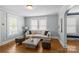Inviting living room featuring hardwood floors, neutral decor, and ample natural light from large windows at 1600 Onslow Dr, Charlotte, NC 28205