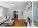 Bright living room with hardwood floors, fireplace, neutral furniture, and views into the dining room at 1600 Onslow Dr, Charlotte, NC 28205