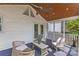 Charming screened porch with wicker furniture and a light-colored stone tile coffee table at 1600 Onslow Dr, Charlotte, NC 28205