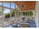 Relaxing screened porch with wicker furniture, wood ceiling, and views of the yard at 1600 Onslow Dr, Charlotte, NC 28205
