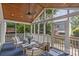 Inviting screened porch with wicker furniture, wood ceiling, and view to the backyard at 1600 Onslow Dr, Charlotte, NC 28205