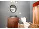Bathroom featuring a wood vanity, a round mirror, and a toilet at 1637 N College Ave, Newton, NC 28658