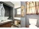 Bathroom featuring decorative tiles, a glass bowl sink, a soaking tub, and natural light from the window at 1637 N College Ave, Newton, NC 28658