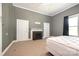 Spacious bedroom featuring neutral walls, carpet, and an electric fireplace adding warmth and comfort at 1637 N College Ave, Newton, NC 28658