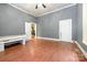 Bedroom featuring wood floors, a ceiling fan, and multiple doors at 1637 N College Ave, Newton, NC 28658