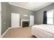 Bedroom featuring neutral walls, carpet, and an electric fireplace adding warmth and comfort at 1637 N College Ave, Newton, NC 28658