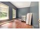 Bedroom featuring wood floors, two windows, and a light-colored walls at 1637 N College Ave, Newton, NC 28658
