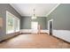 Bright dining room with large windows and unfinished flooring, ready for personalization at 1637 N College Ave, Newton, NC 28658