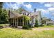 Exterior view of a home with a screened porch and vibrant blue hydrangeas at 1637 N College Ave, Newton, NC 28658