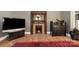 Living room featuring an original fireplace with wood trim and active fire at 1637 N College Ave, Newton, NC 28658