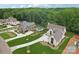 Expansive aerial view of a luxury home with a pool and beautifully landscaped grounds at 213 Crest Ct, Weddington, NC 28104