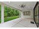 Covered patio overlooking a lush green lawn with ceiling fan, perfect for outdoor relaxation at 213 Crest Ct, Weddington, NC 28104