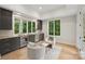 Sitting area with bar, beverage center, and ample light from the many large windows at 213 Crest Ct, Weddington, NC 28104