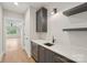 Bar area with modern gray cabinetry, wine fridge, floating shelves, and attractive fixtures at 213 Crest Ct, Weddington, NC 28104