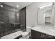 Modern bathroom featuring a black tiled shower with glass door and stylish vanity with sleek white countertop at 213 Crest Ct, Weddington, NC 28104