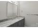 Bathroom with a vanity featuring a granite countertop, undermount sink and sleek chrome fixtures at 213 Crest Ct, Weddington, NC 28104