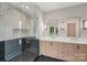Contemporary bathroom featuring a glass-enclosed shower, double vanity, and stylish lighting at 213 Crest Ct, Weddington, NC 28104