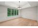 Bright bedroom with hardwood floors and large windows offering a scenic view of the outdoors at 213 Crest Ct, Weddington, NC 28104
