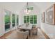 Airy dining room with large windows, stylish lighting, and access to the outdoor patio at 213 Crest Ct, Weddington, NC 28104