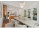 Open-concept dining room showcases a modern chandelier, comfortable seating, and seamless flow into the kitchen at 213 Crest Ct, Weddington, NC 28104