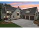 Stunning painted-brick home featuring a three-car garage and meticulous landscaping at 213 Crest Ct, Weddington, NC 28104