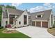 Impressive home with a large driveway leading to three-car garage and meticulously maintained front yard at 213 Crest Ct, Weddington, NC 28104