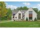 Elegant home with manicured lawn and professional landscaping showcasing its sophisticated architecture at 213 Crest Ct, Weddington, NC 28104