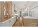 Modern kitchen with stainless steel appliances, custom cabinetry, a large island with seating, and hardwood flooring at 213 Crest Ct, Weddington, NC 28104