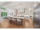 Modern kitchen features a large island with seating, stainless steel appliances, and a bright, airy dining area at 213 Crest Ct, Weddington, NC 28104
