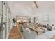 Light-filled living room features high ceilings with exposed wood beams, neutral furnishings, and hardwood floors at 213 Crest Ct, Weddington, NC 28104