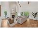 Bright living room featuring hardwood floors, a fireplace, and plenty of natural light at 213 Crest Ct, Weddington, NC 28104